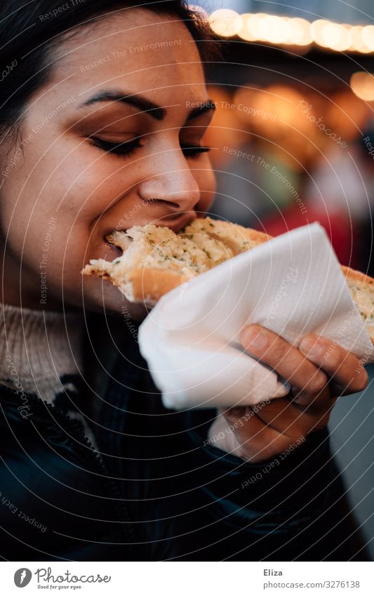 delicatessen Feminine Young woman Youth (Young adults) Woman Adults 18 - 30 years Eating To enjoy garlic bread Christmas Fair Appetite Delicious Hearty