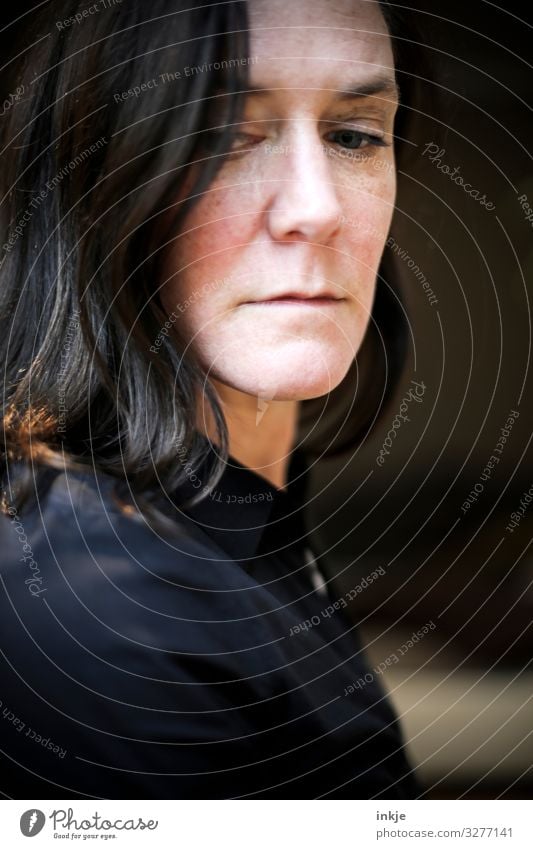 high-contrast portrait of a woman Interior lining Colour photo Close-up Shallow depth of field pale Dark-haired Long-haired naturally Authentic Without makeup