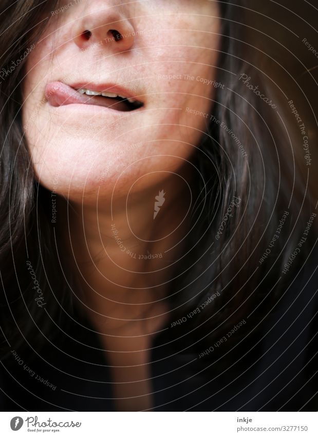 Close-up of a woman's mouth with tip of the tongue at the corner of the mouth Interior shot portrait portrait of a woman Mouth facial expression Tongue