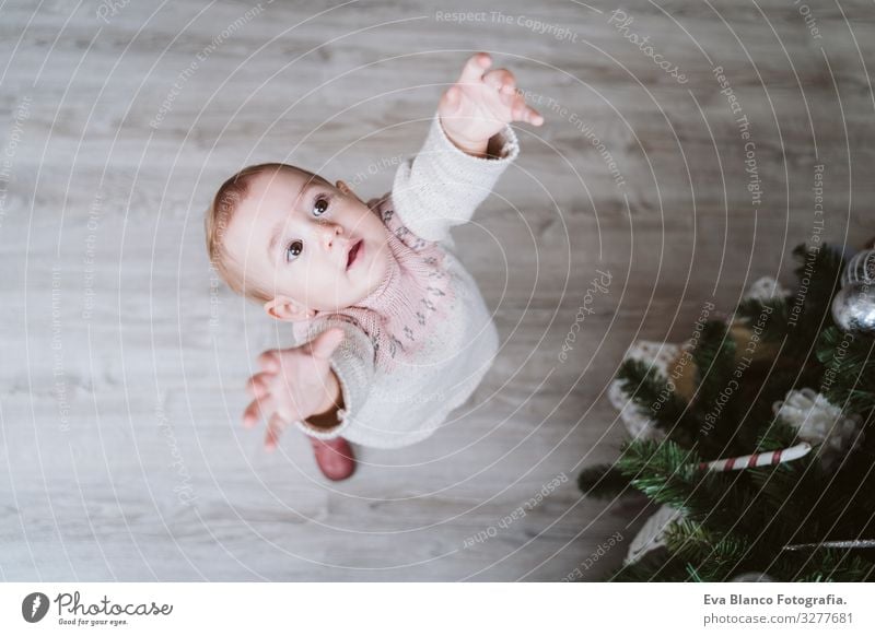 cute baby girl decorating the Christmas tree Cute Baby Girl one year Christmas & Advent Tree Joy Family & Relations Love Decoration Infancy motherhood