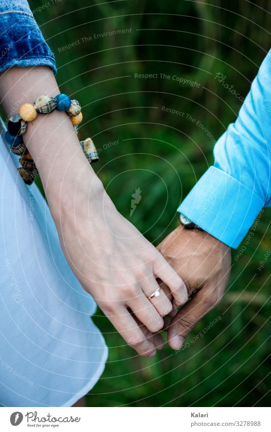 A couple holding hands with engagement ring and blue clothes Couple at the same time Hand stop Wedding People Woman Bride Married couple wedding ceremony Arise