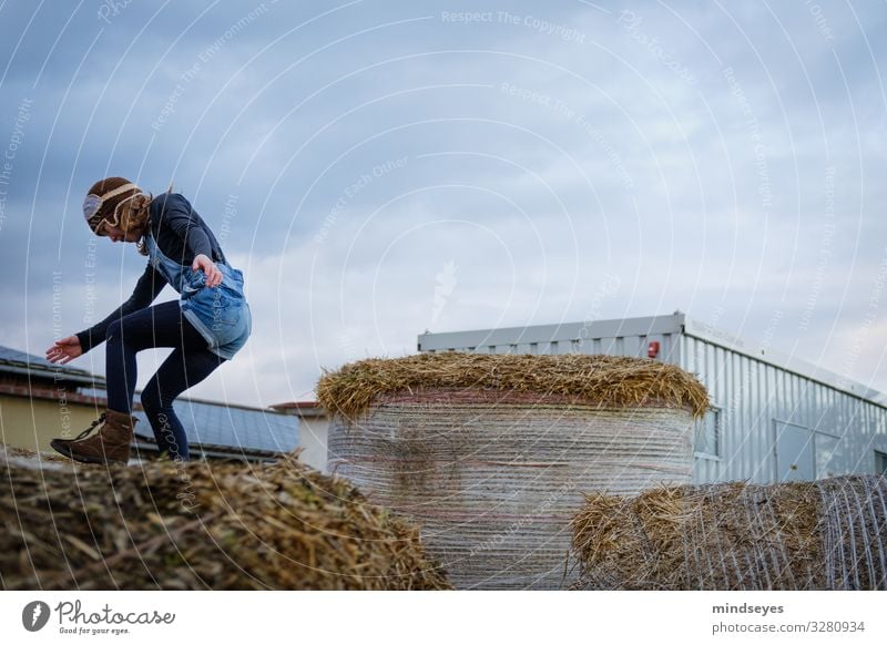 The Landing Joy Leisure and hobbies Playing Farm Child Girl 1 Human being 3 - 8 years Infancy Clouds Straw Bale of straw Cap Flying Jump Happiness Healthy Happy