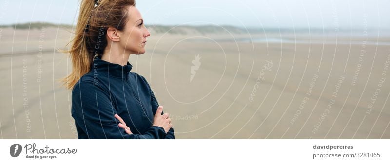 Woman looking at sea on beach in autumn Lifestyle Beautiful Meditation Beach Ocean Internet Human being Adults Sand Autumn Fog Think Sadness Authentic