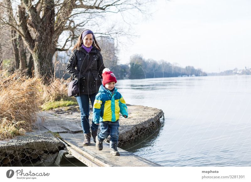 Mother walks with her little son over a wooden jetty on the water, Rhine Woman Human being Fear watch balance bridge Family River Going in common Wooden bridge