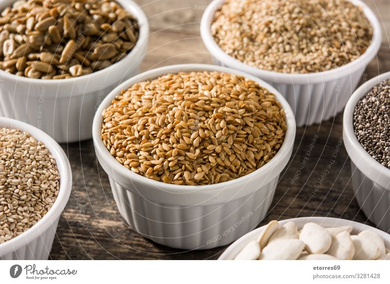 Assortment of different seeds in bowl on wooden table. Food Healthy Eating Food photograph Seed Seeds Ingredients Grain Exceptional Pumpkin linen chia Sunflower