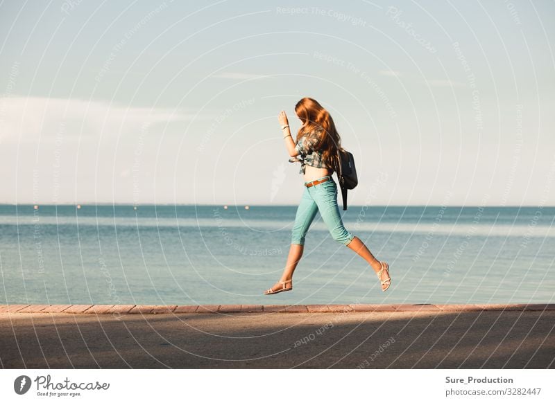 young woman is jump in front of sea action sky beautiful summer freedom outdoor travel healthy beauty white active cheerful energy happiness happy joy lifestyle