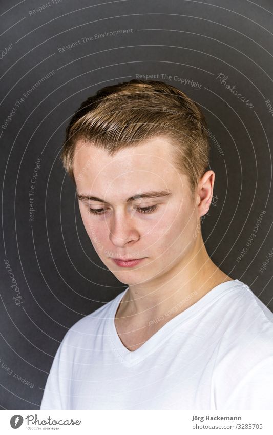 portrait of sad looking teenage boy Joy Happy Beautiful Face Child Human being Boy (child) Man Adults Youth (Young adults) Shirt Think Happiness Cute White