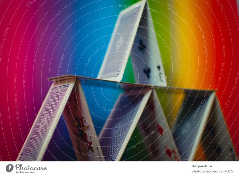 Cards gimmick / architecture. Playing cards built up to a house. The background colors are colorful. Design Harmonious Game of cards Architecture