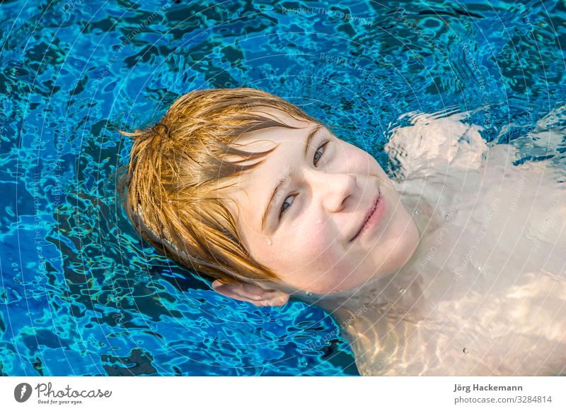 boy enjoys floating on his back Joy Happy Relaxation Swimming pool Vacation & Travel Summer Boy (child) Youth (Young adults) Smiling Cute Thailand Asia