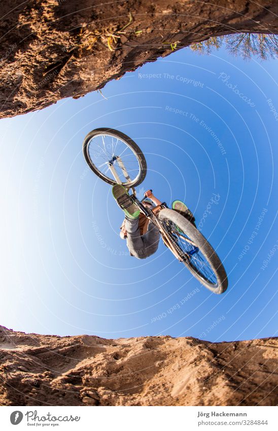 boy going airborne with a dirt bike Lifestyle Joy Happy Leisure and hobbies Child Human being Boy (child) Man Adults Infancy Youth (Young adults) Sky Park