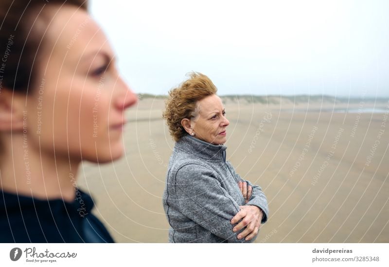 Two women looking sea on beach in autumn Lifestyle Beautiful Meditation Beach Ocean Human being Woman Adults Mother Grandmother Family & Relations Sand Autumn