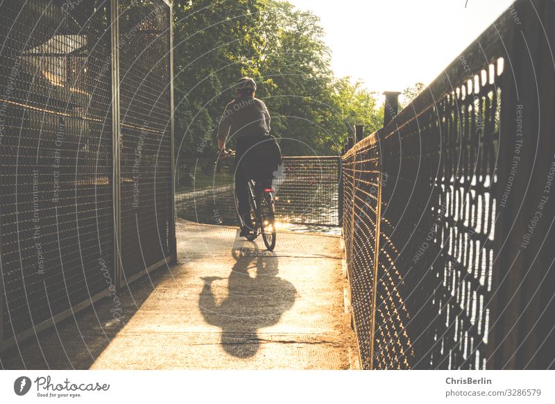 Shadow of a cyclist Athletic Contentment Senses Leisure and hobbies Cycling Trip Cycling tour Summer Adults 1 Human being Landscape Beautiful weather River Town