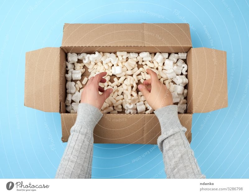 female hands hold an empty open box Craft (trade) Mail Business Hand Bottom Transport Container Paper Packaging Package Above Clean Brown Yellow White backdrop