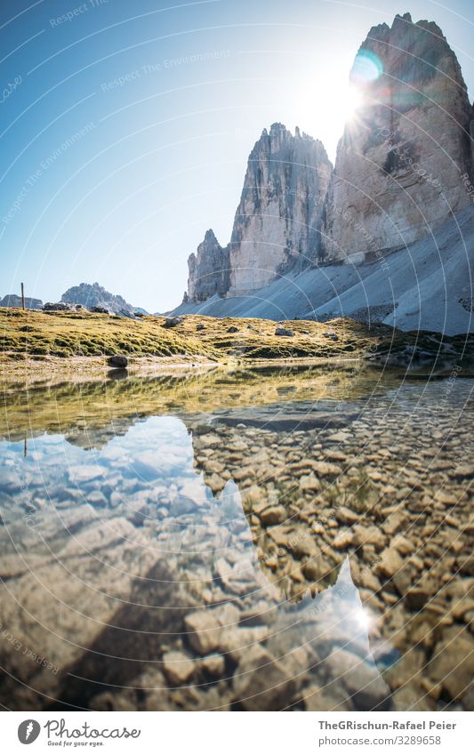 Tre Cime against the light - mountains reflected in the small lake Lake Water Calm Hiking Mountain Tre Cime di Lavaredo popular Tourism Climbing Back-light