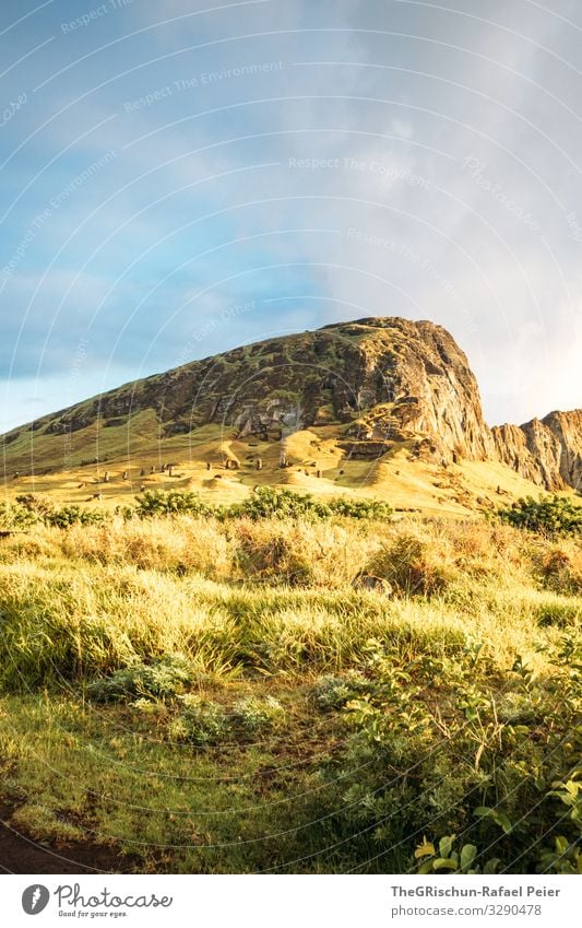 MOAI - Quarry Environment Nature Blue Yellow Gold Green moai Volcano Grass Clouds Moody Sunrise Bushes Easter island Chile Colour photo Exterior shot Deserted