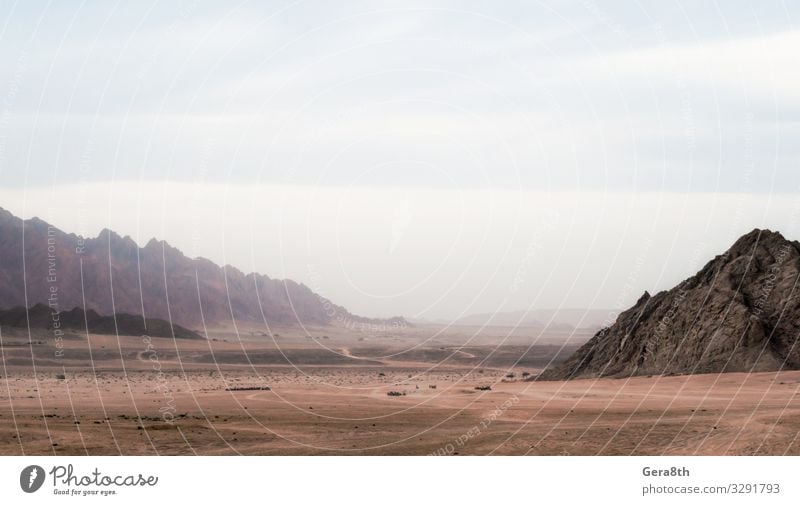 panoramic view of desert with rocky mountains in Egypt Exotic Vacation & Travel Tourism Trip Mountain Nature Landscape Sky Clouds Fog Rock Stone Dark Colour