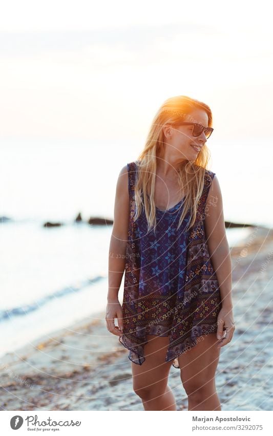 Young woman enjoying sunset on the beach Lifestyle Joy Vacation & Travel Tourism Summer Summer vacation Sun Beach Ocean Human being Feminine