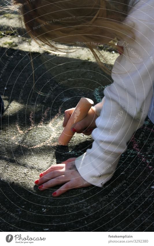 Child draws with a chalk on a stone floor Children's game Toddler Girl Infancy Hand 1 Human being 3 - 8 years Art Street art Painting (action, artwork) crayon