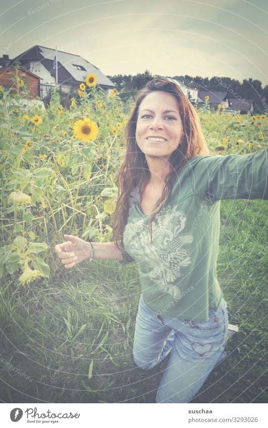 woman making a selfie in front of a sunflower meadow Woman Hippie long hairs flower girl feminine Selfie Meadow Flower meadow Sunflowers Place