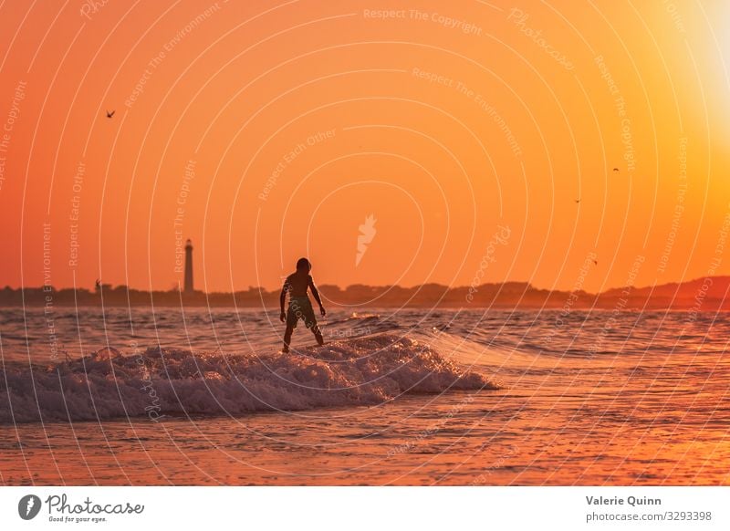 Sunset Surfing Vacation & Travel Summer Summer vacation Beach Ocean Waves Surfboard Boy (child) 1 Human being 8 - 13 years Child Infancy Water Sky Coast