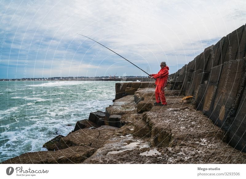 Old man fishing in the sea. Lifestyle Happy Relaxation Leisure and hobbies Playing Vacation & Travel Ocean Sports Retirement Human being Man Adults