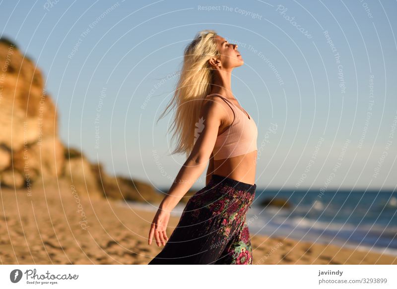 Woman enjoying the sunset on a beautiful beach Lifestyle Happy Beautiful Body Relaxation Meditation Leisure and hobbies Vacation & Travel Freedom Summer Sun