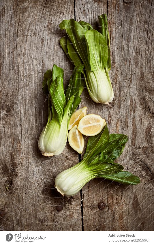 Bok choy on wooden table bok choy vegetable fresh ripe vintage plate shabby food green ingredient healthy raw leaf vegetarian vegan vitamin pak choi kitchen