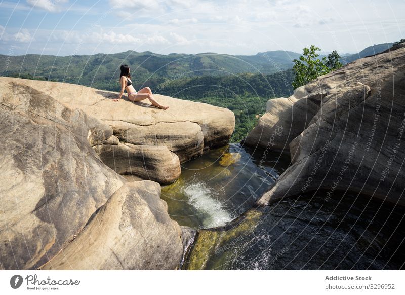 Inspired woman swimming in stony pool in mountain waterfall relaxation fun vacation holiday travel aqua recreation swimwear paradise rock nature landscape stone