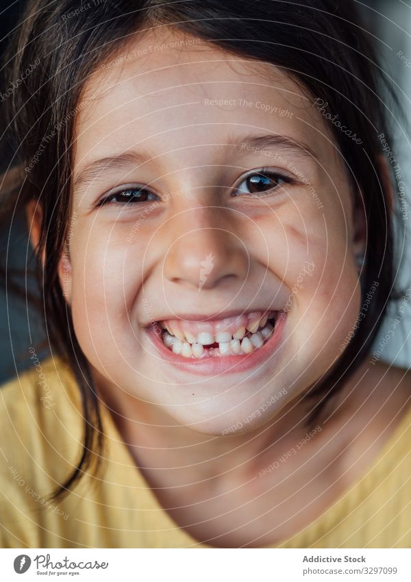 Toothless girl smiling for camera smile toothless little happy rest show hole kid casual brunette child funny cheerful joy glad pleased gleeful merry