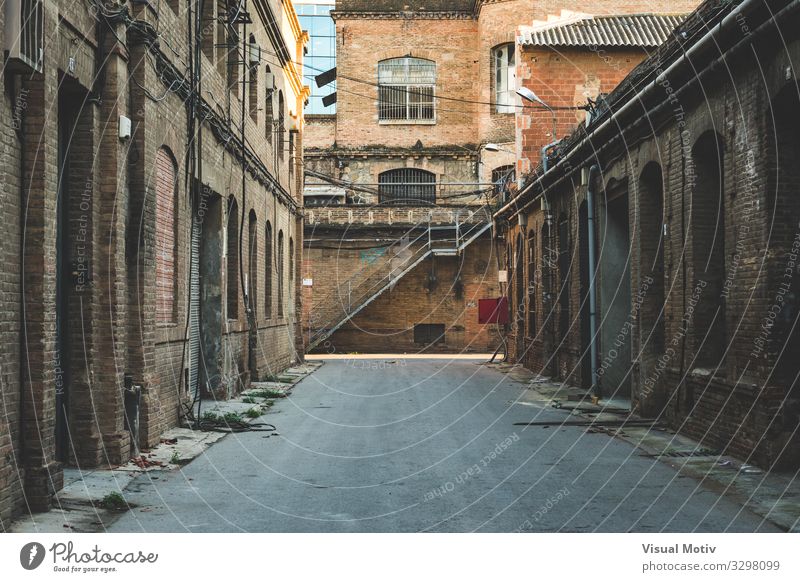 Frontal perspective of the alley of an old textile factory Capital city Industrial plant Factory Manmade structures Building Architecture Lanes & trails Alley