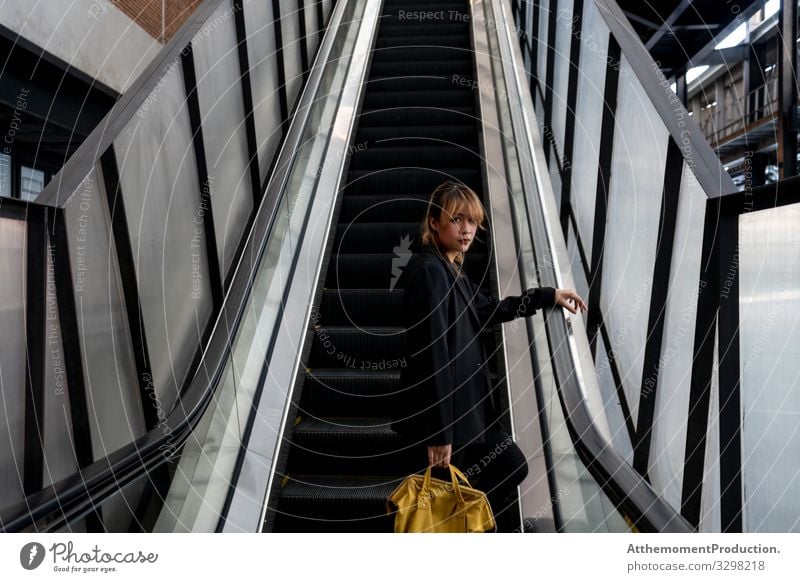 Woman on escalator. Lifestyle Style Beautiful Calm Vacation & Travel Closing time Human being Adults Escalator Fashion Suit Jacket Sneakers Stand Cool (slang)