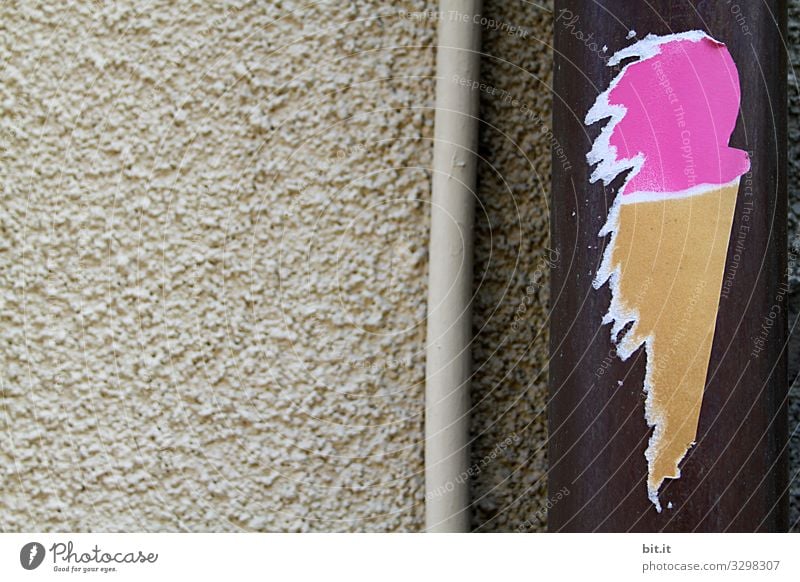 Funny, homemade sticker in the form of ice cream with ice cream ball in pink and ice cream waffle, sticks artfully, as a sticker made of paper, on a rain gutter on beige stone wall, in the city and invites you to eat ice cream.