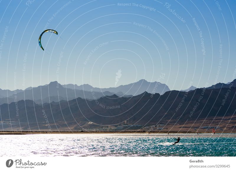 kitesurfer rides in the Red Sea in Egypt Dahab Exotic Vacation & Travel Tourism Summer Ocean Waves Mountain Sports Aquatics Nature Landscape Sky Horizon Wind