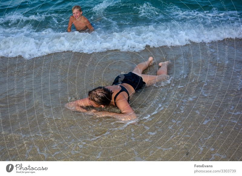 Two children on the beach in the waves Joy Vacation & Travel Summer Beach Human being Brothers and sisters Youth (Young adults) 2 8 - 13 years Child Infancy