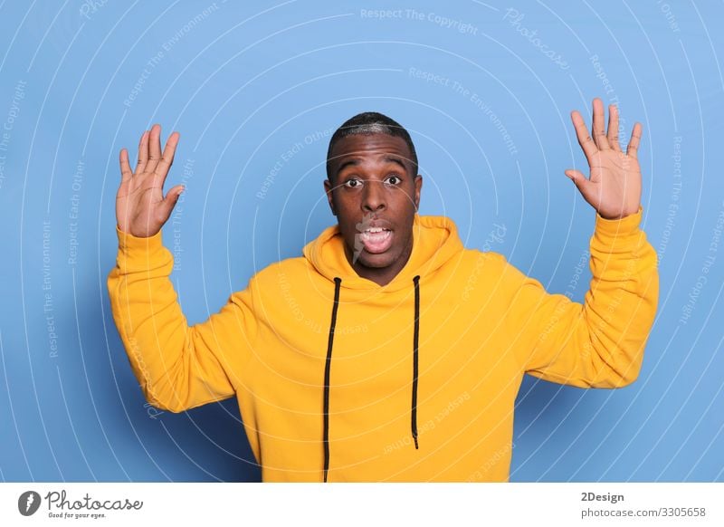 A young attractive man looking suprised isolated on blue background Happy Face Human being Masculine Young man Youth (Young adults) Man Adults 1 18 - 30 years