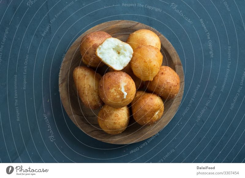 Colombian buñuelo - Deep Fried Cheese Bread Diet about view black background colombian food Frying sweet tradicional wooden plate Bird's-eye view