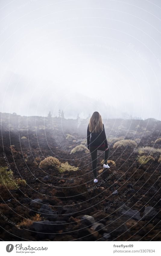 Young woman contemplating the fog Lifestyle Tourism Hiking Human being Youth (Young adults) Woman Adults 1 18 - 30 years Nature Landscape Clouds Fog Rain Rock