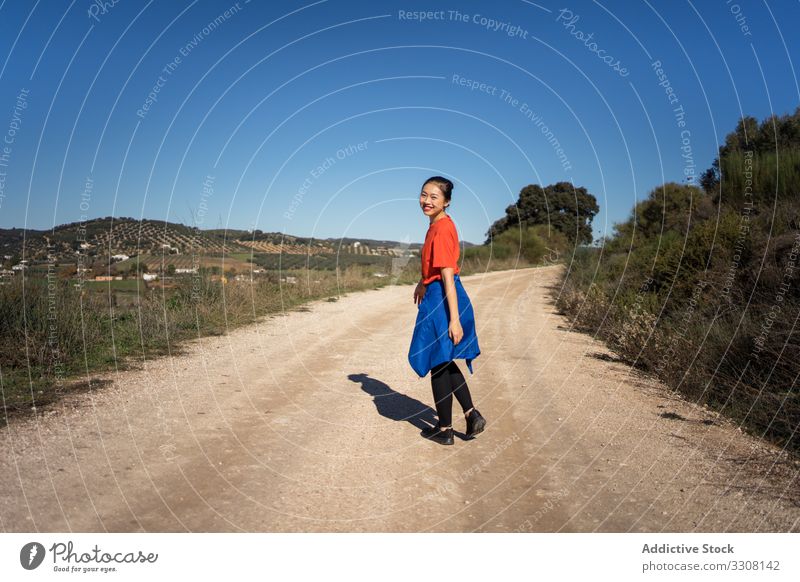 Smiling Asian woman walking on road in countryside nature asian smiling charming way female young healthy natural vacation relax human freedom path model calm