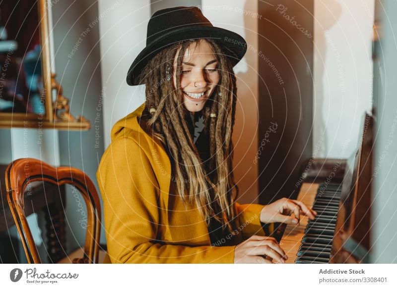 Hipster millennial woman playing piano dreadlocks hipster music stylish sit female focused concentrated practicing musician instrument art pianist melody key