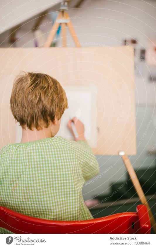 Kid drawing on canvas at home child picture kid boy art serious calm paint hobby peaceful casual house childhood apartment flat creative free time relax day