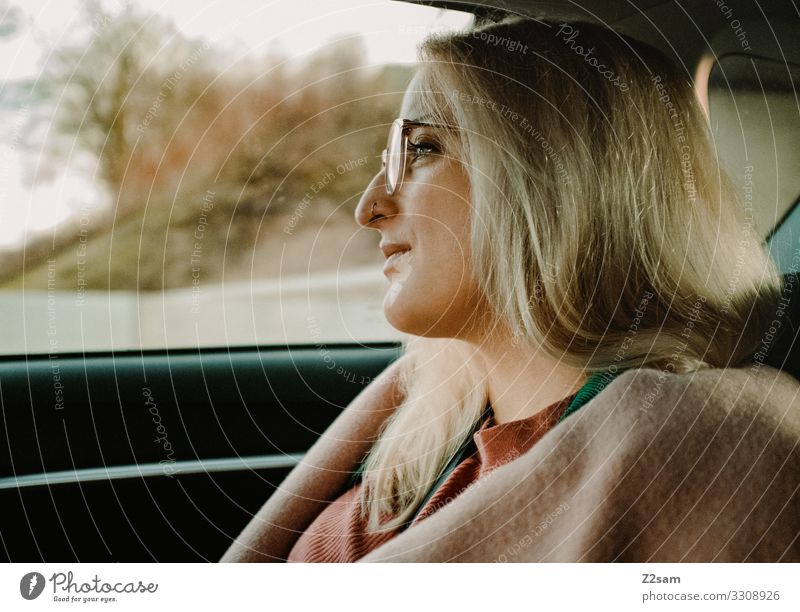 Thoughtful Meditative travel car Rear seat pretty Blonde Eyeglasses Fashion fashionable Coat pink Pink limosine Think Beautiful youthful Profile Face lines