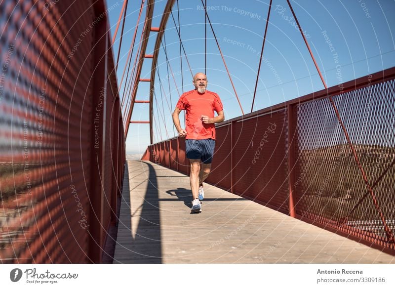 Senior runner training on a bridge Lifestyle Sports Human being Man Adults Bridge Bald or shaved head Beard Old Fitness Red White Serene Effort Runner senior