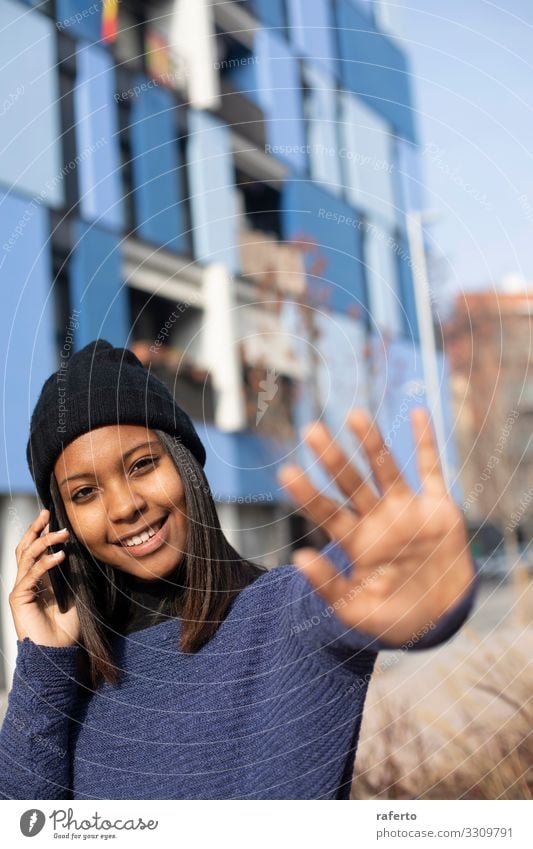 young beautiful woman standing while using a mobile phone Lifestyle Happy Beautiful Telephone PDA Technology Internet Human being Feminine Young woman