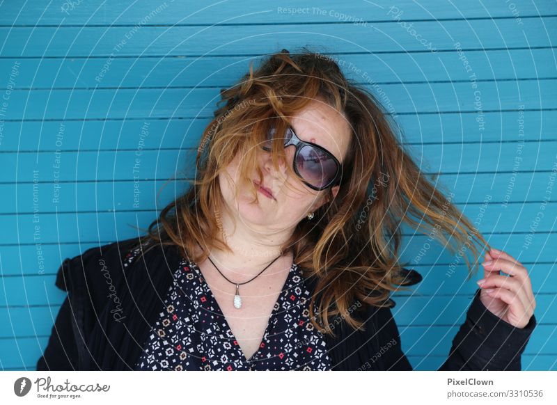 Young woman in front of a blue wall Woman portrait Human being Feminine Exterior shot Face Long-haired Hair and hairstyles Blue