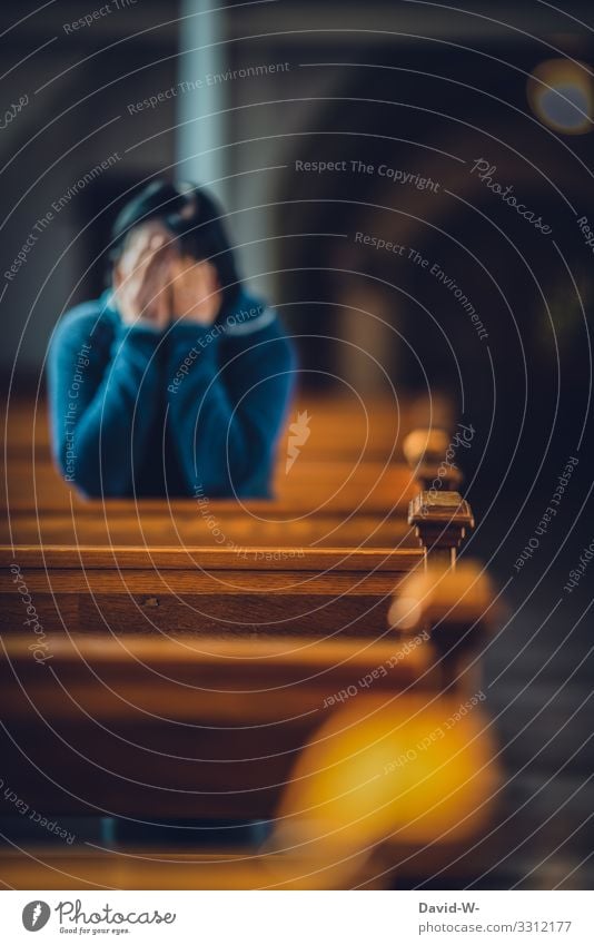 praying - woman kneels in a pew and puts her hands in front of her face praise of God Church Church window Testament Religion and faith Belief Book Prayer