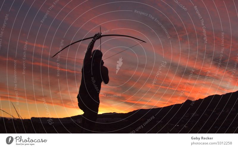 The shot into infinity Lifestyle Joy Leisure and hobbies Hunting Arrow Adventure Archer Nature Sunrise Sunset Mountain Stand Athletic Eroticism Enthusiasm Brave