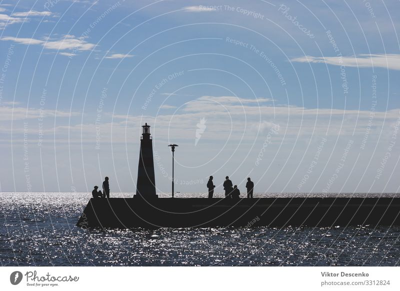 People at sea with a lighthouse in autumn Beautiful Vacation & Travel Tourism Summer Sun Beach Ocean Island Waves Human being Woman Adults Man Nature Landscape