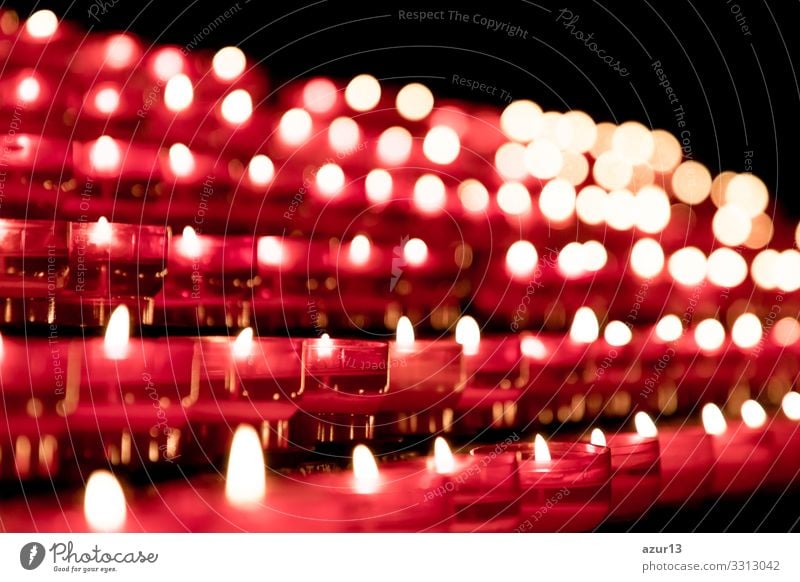 Group of red candles in church for faith resurrection prayer. Candlelight fire flames in rows. Sign Love Power Peace Religion and faith hope faithful sacrifice