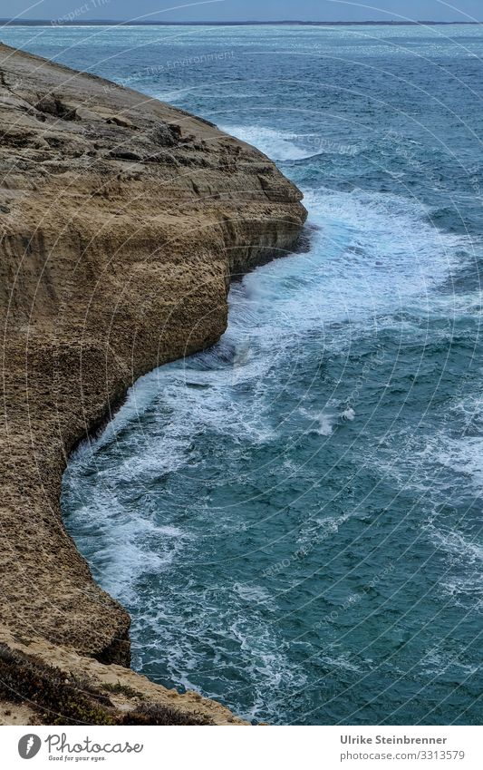 Rugged cliff in the Mediterranean Sea Ocean Mediterranean sea Waves Water Surf Cliff Rock Sardinia Coast Steep Stone somber Evening curt Nature Landscape