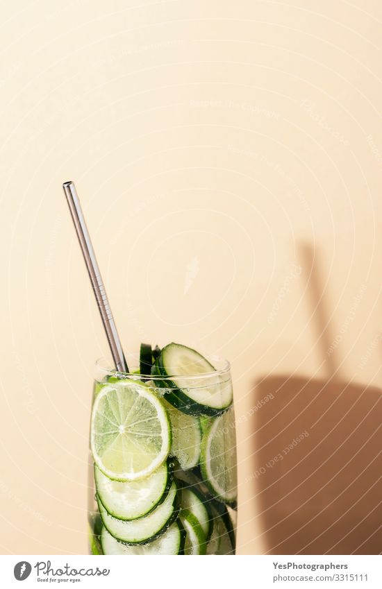 Lemonade glass with cucumber and lime. Summer cocktail Beverage Cold drink Drinking water Green antioxidant Air bubble Copy Space cucumber drink detox drink